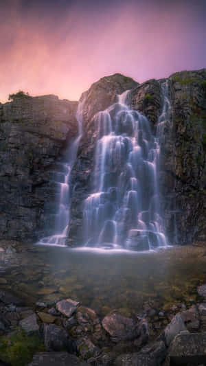 The Refreshing Beauty Of An Iphone Waterfall And Its Lush Surroundings Wallpaper