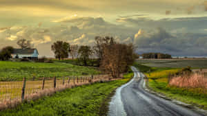 The Simplicity Of Nature: A Tractor Rides Through An Endless Field Of Wheat Wallpaper