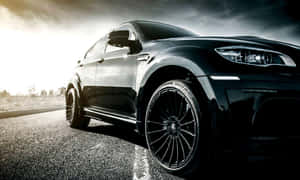 The Stylish And Luxurious Bmw X6 In Motion Wallpaper