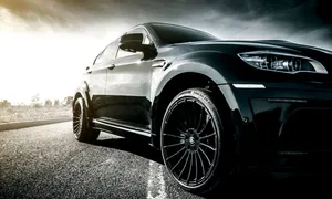 The Stylish And Luxurious Bmw X6 In Motion Wallpaper