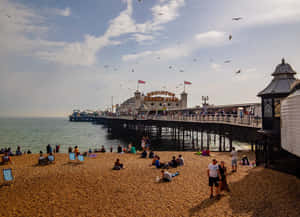 The Vibrant Brighton Pier At Sunset Wallpaper