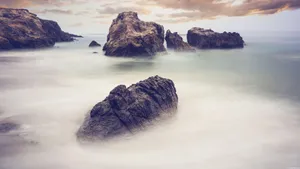 Thick Rocks Against Dark Sky Wallpaper