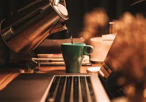 Thick White Clouds Frame A Snow-capped Mountain Rising Above A Lake In Alaska Wallpaper