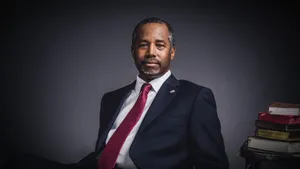 Thoughtful Ben Carson With His Remarkable Book Collections Wallpaper