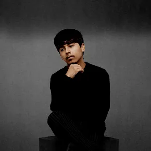 Thoughtful Young Manin Black Sweater Wallpaper