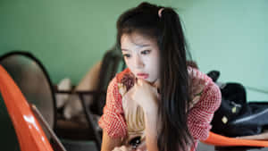 Thoughtful Young Woman Indoors Wallpaper