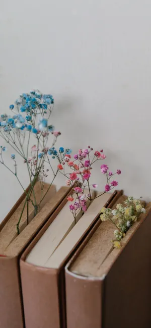 Three Books With Flowers On Them Wallpaper