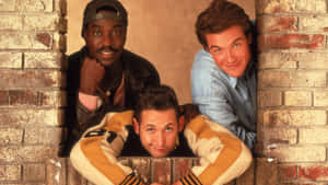 Three_ Comedians_ Brick_ Wall_ Backdrop Wallpaper