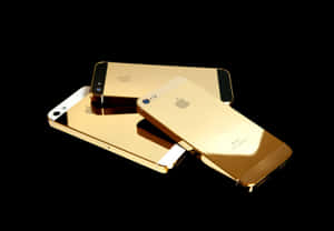 Three Gold Iphones On A Black Background Wallpaper
