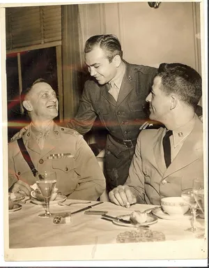 Three Men In Uniforms Sitting At A Table Wallpaper