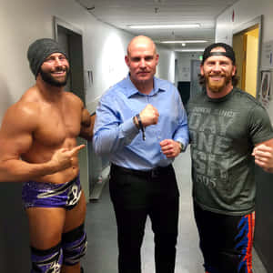 Three Men Posing Backstage Wallpaper