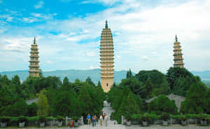 Three Pagodas With Tourists Wallpaper