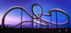 Thrilling Adventure On A Looping Roller Coaster Wallpaper