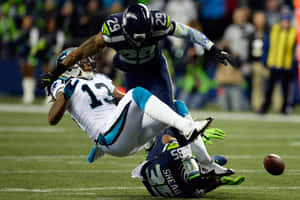 Thrilling Moment Of Football Tackle Wallpaper