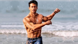 Tiger Shroff Beach Splash Wallpaper