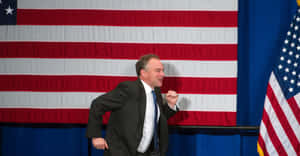 Tim Kaine Running In Front Of Flag Wallpaper