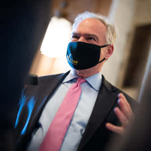 Tim Kaine Wearing A Black Face Mask Wallpaper