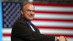 Tim Kaine With Us Flag Background Wallpaper