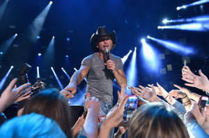 Tim Mcgraw Reaching To Fans Stage Wallpaper