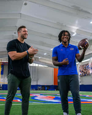 Tim Tebow Making A Yard At An Nfl Game. Wallpaper