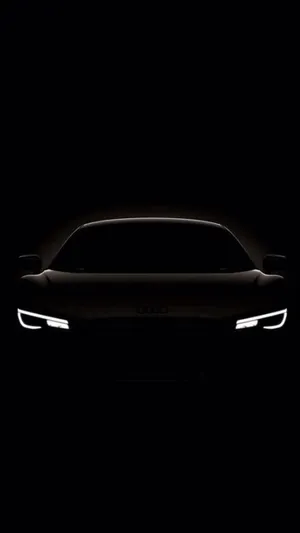 Timeless Elegance - A Black And White Convertible Car On The Road Wallpaper