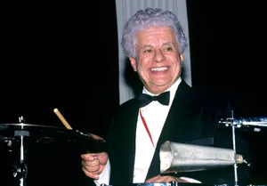 Tito Puente Smiling While Drumming Wallpaper