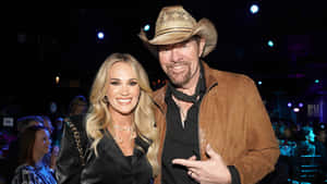 Toby Keith Event Smiling With Female Companion Wallpaper