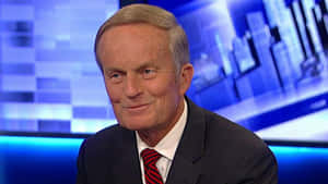 Todd Akin Standing Against A Building Background Wallpaper