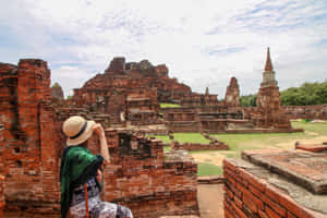 Tourist Exploring Ayutthaya Ruins Wallpaper