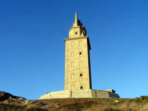 Tower Of Hercules Contrasting With The Blue Sky Wallpaper