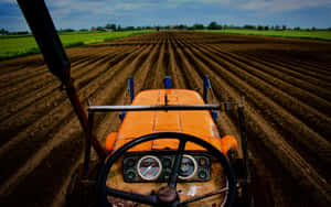 Tractor Plowing Farmland Wallpaper