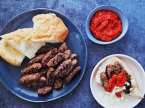 Traditional Cevapi Served With Warm Pita Bread Wallpaper