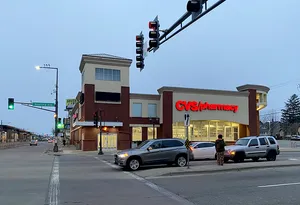 Traffic In Front Of A Cvs Pharmacy Wallpaper