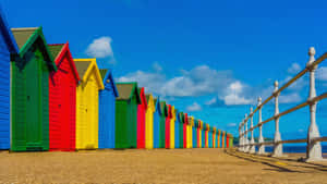 Tranquil Beach Huts Overlooking The Ocean Wallpaper