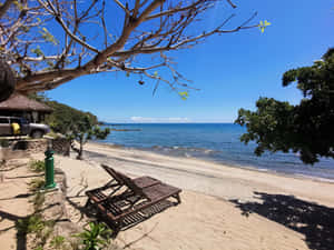 Tranquil Beach Resort Under The Serene Sky Wallpaper