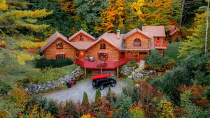 Tranquil Fall Cabin Nestled In Autumn Foliage Wallpaper