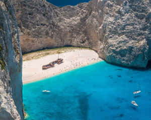 Tranquil Mediterranean Beach At Sunset Wallpaper