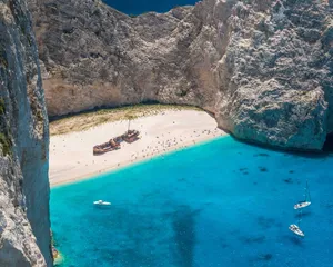 Tranquil Mediterranean Beach At Sunset Wallpaper