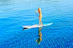 Tranquil Paddleboarding Adventure At Sunset Wallpaper