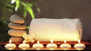 Tranquil Spa Settingwith Candlesand Stones Wallpaper