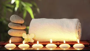 Tranquil Spa Settingwith Candlesand Stones Wallpaper