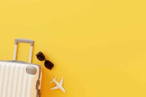 Travel Essentials Yellow Background Wallpaper