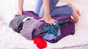 - Travel In Style With Purple Luggage Wallpaper