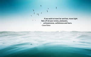 Travel Light Quote Over Ocean View Wallpaper