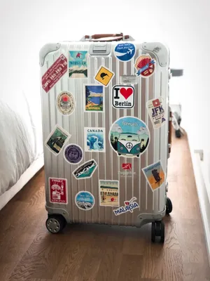 Travel Sticker Covered Suitcase Wallpaper