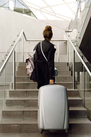 Traveler With Suitcase Climbing Stairs Wallpaper