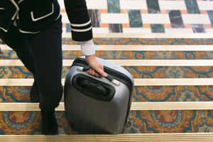 Traveler With Suitcase On Stairs Wallpaper