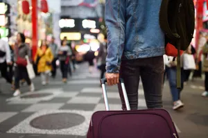 Traveling The World With A Stylish Purple Suitcase Wallpaper
