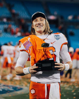 Trevor Lawrence Holding Trophy Wallpaper