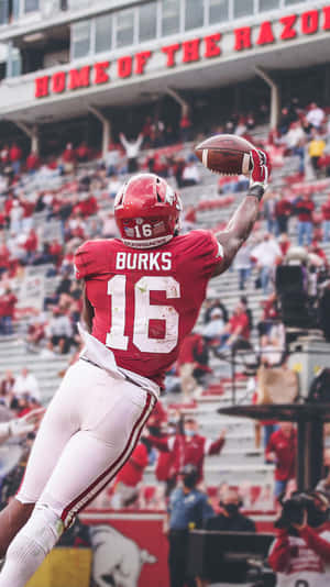 Treylon Burks Catching Football Wallpaper